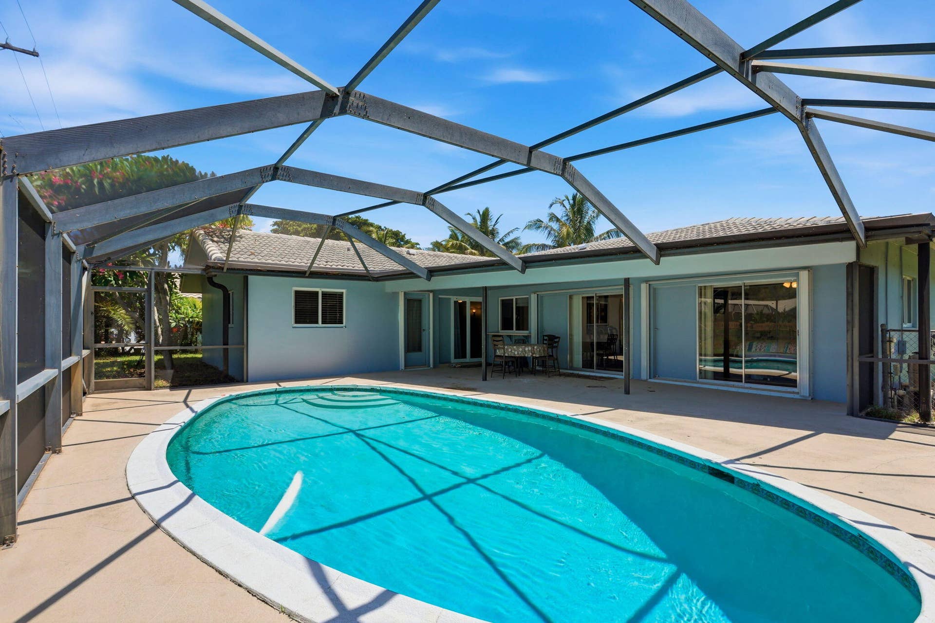 115 Orchard Ridge Lane, Boca Raton, FL 33431 Screen enclosed patio/pool with large overhang.