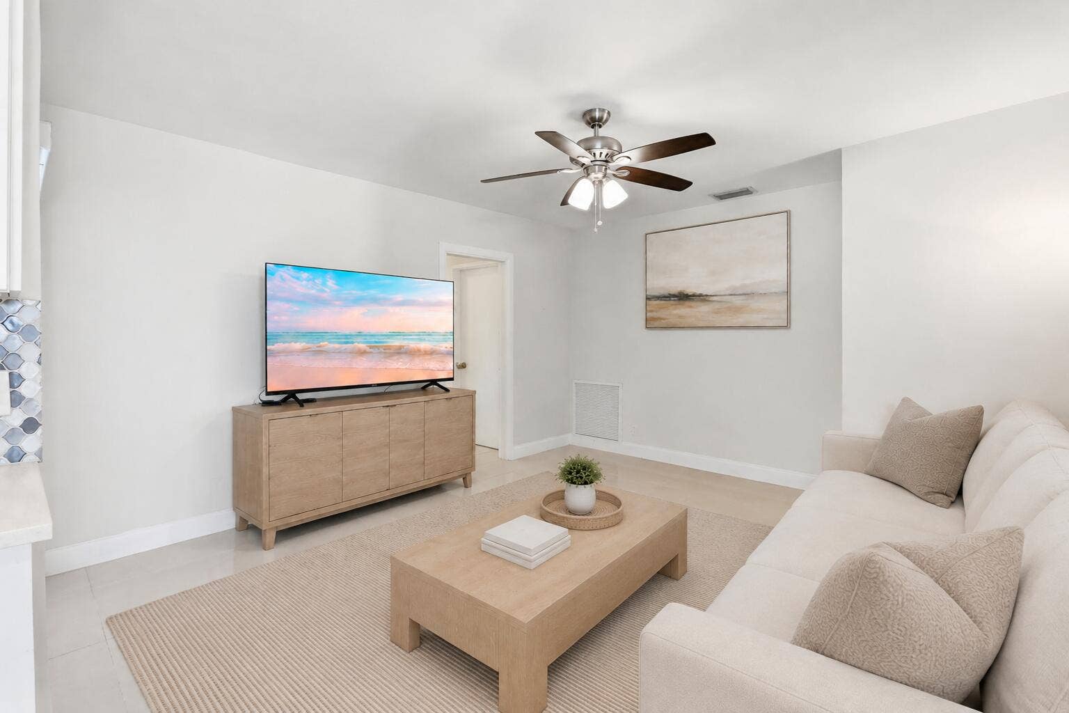 115 Orchard Ridge Lane, Boca Raton, FL 33431 Family Room leads to cabana bath and two bedrooms. (virtually staged for illustrative purposes; no permanent features or finishes have been altered)