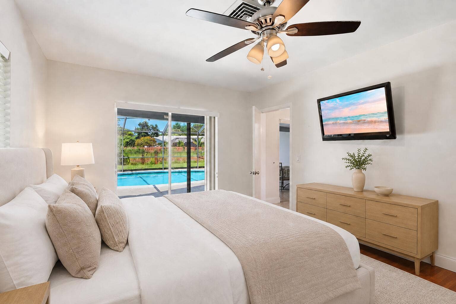 115 Orchard Ridge Lane, Boca Raton, FL 33431 Primary bedroom has direct access to patio/pool. (virtually staged for illustrative purposes; no permanent features or finishes have been altered)