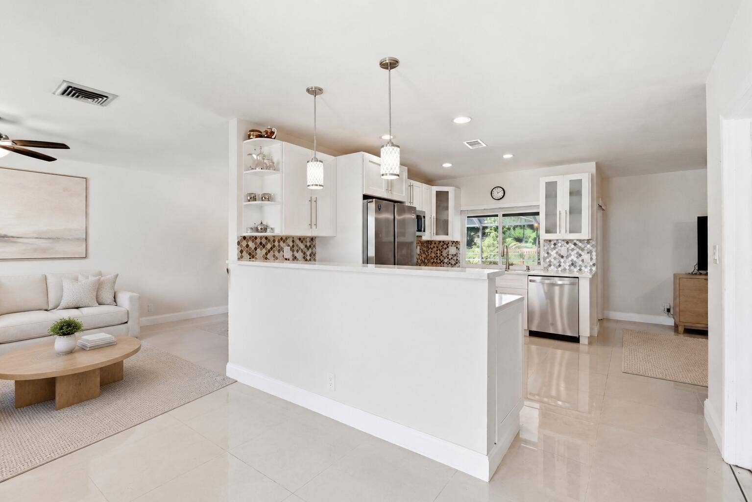 115 Orchard Ridge Lane, Boca Raton, FL 33431 Kitchen centers the home. (virtually staged for illustrative purposes; no permanent features or finishes have been altered)