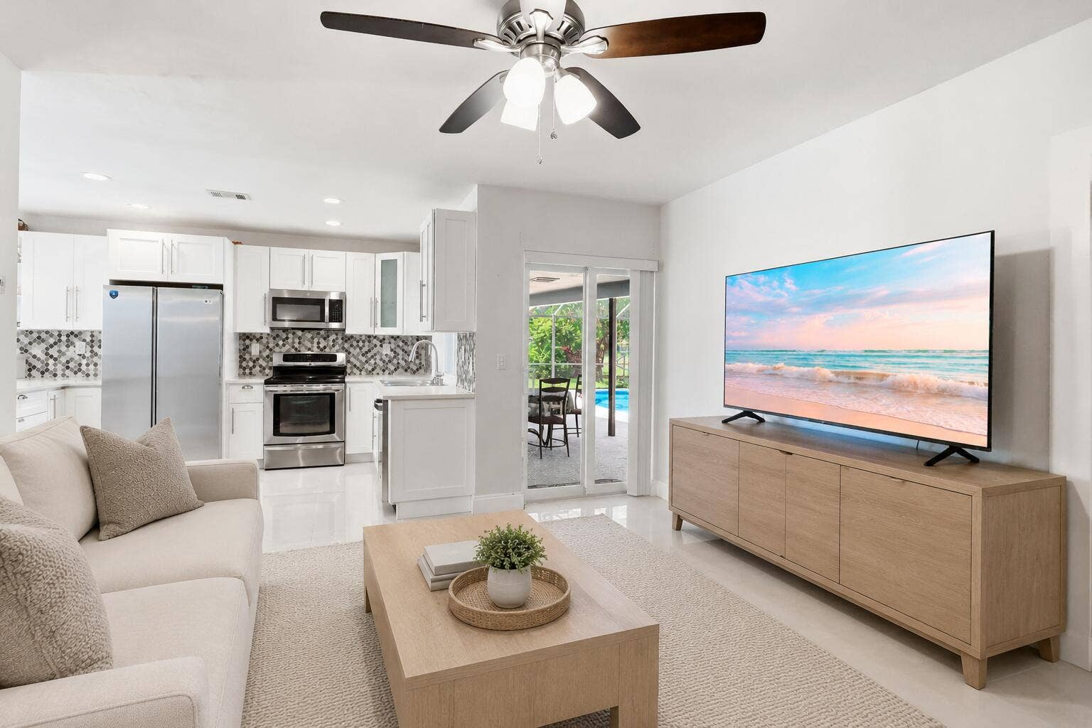 115 Orchard Ridge Lane, Boca Raton, FL 33431 Family Room with access to patio/pool. (virtually staged for illustrative purposes; no permanent features or finishes have been altered)