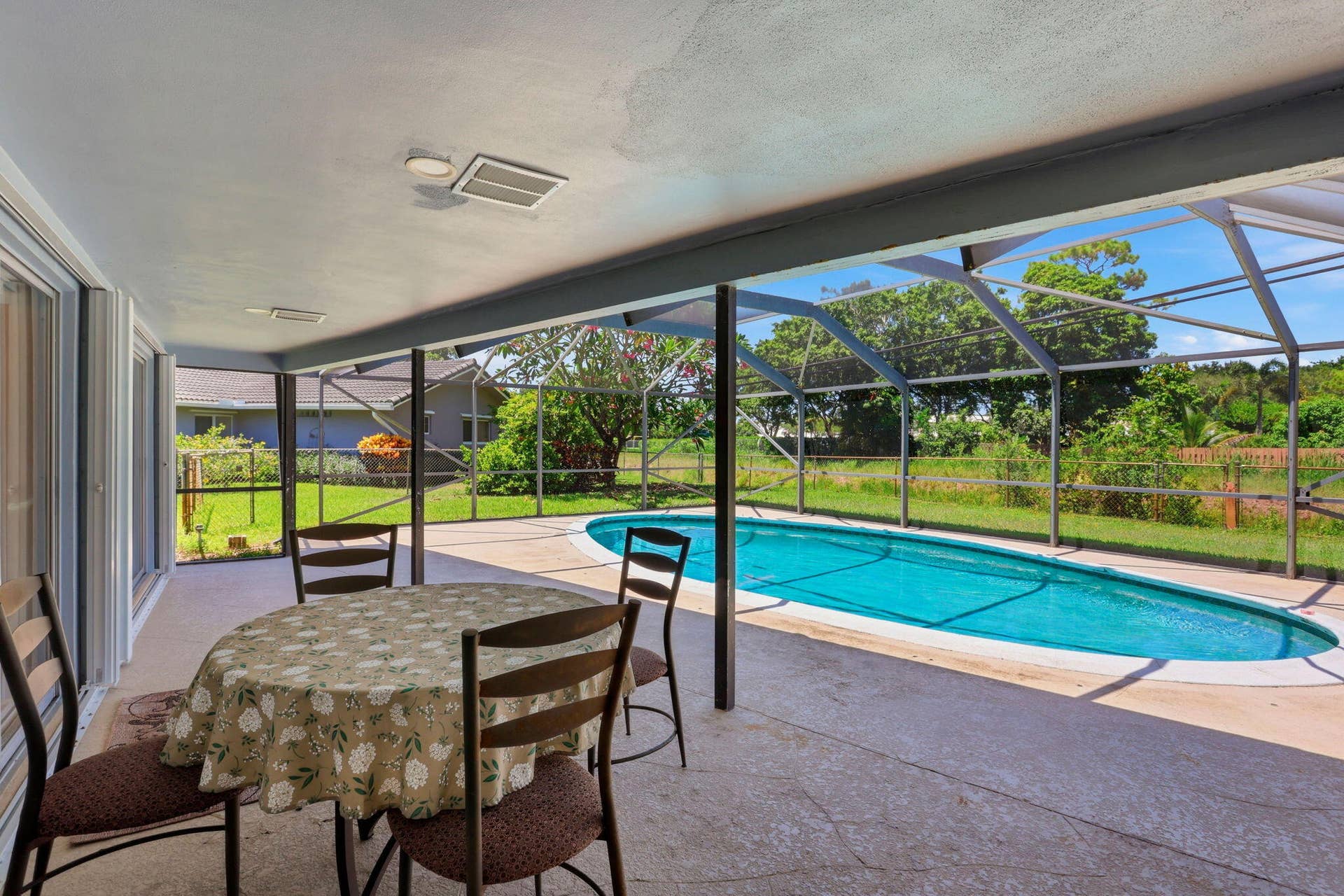 115 Orchard Ridge Lane, Boca Raton, FL 33431 Screen enclosed patio/pool with large overhang.