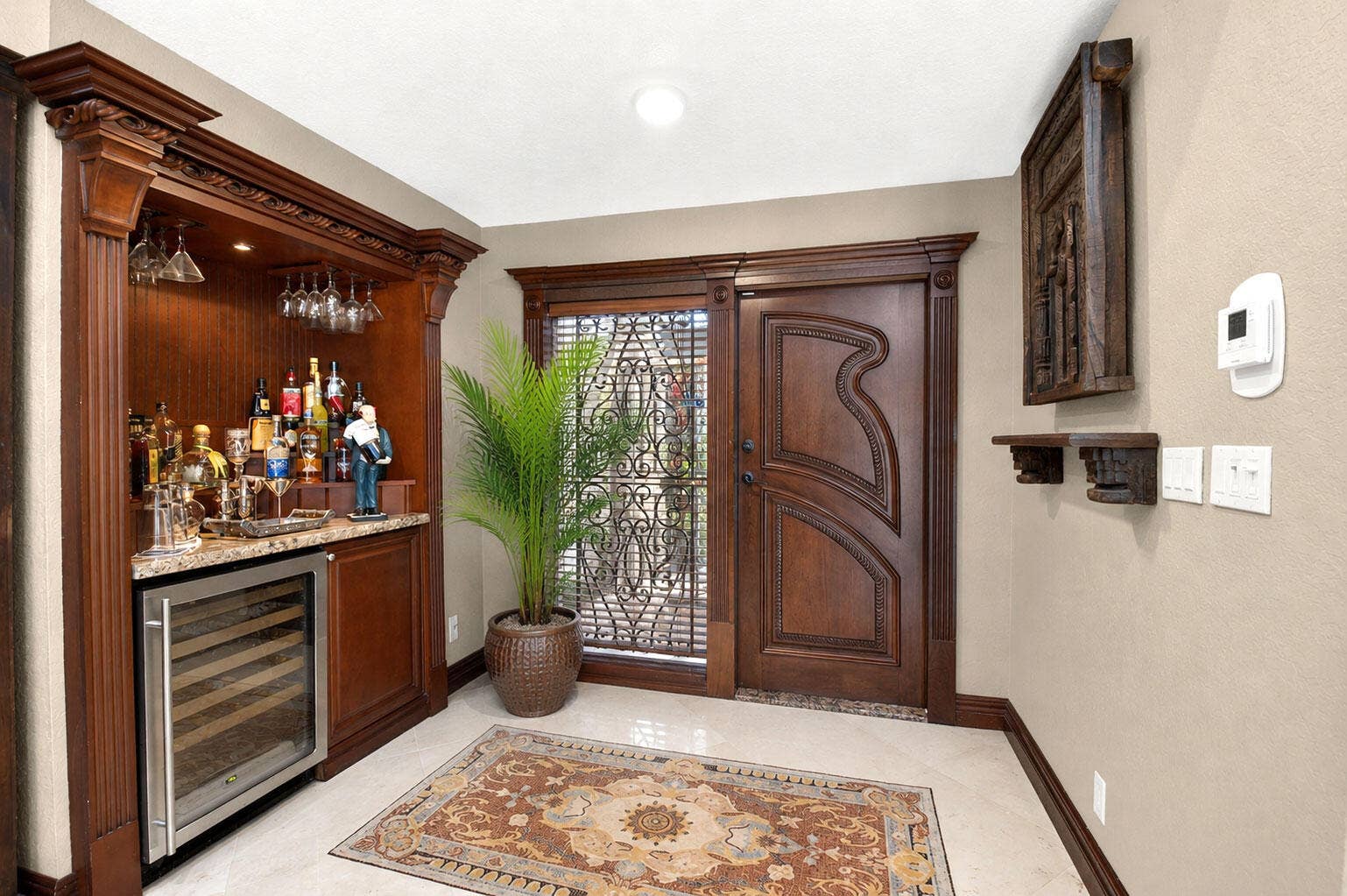 663 DEER CREEK HOLLOWS Circle, Deerfield Beach, FL 33442 Mosiac foyer entry equipped with a beautiful bar buildout.