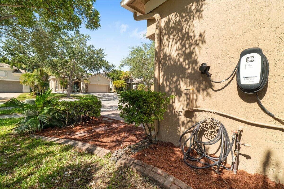 12390 NW 78th Manor, Parkland, FL 33076 The real E.V 220 CHARGER FOR ELECTRIC CARS is installed onto the side of the house with cameras and security system ,
