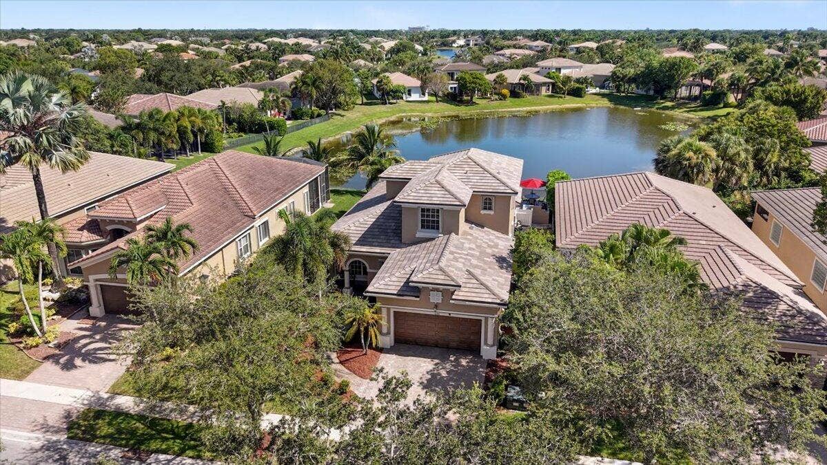 12390 NW 78th Manor, Parkland, FL 33076 Look at that brand new roof and the beautiful lake behind it,