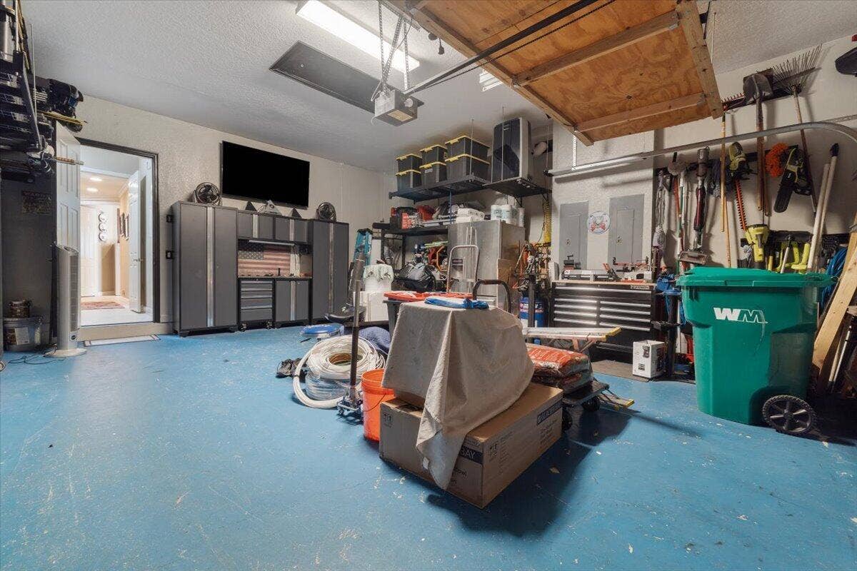 12390 NW 78th Manor, Parkland, FL 33076 This is no ordinary garage, This garage has a fabulous A/C unit to keep you cool while owrking on all your storage filling and yes there is a lot of storage in this garage, All tv's are included but not some of the tool cabinets . ask m which ones,