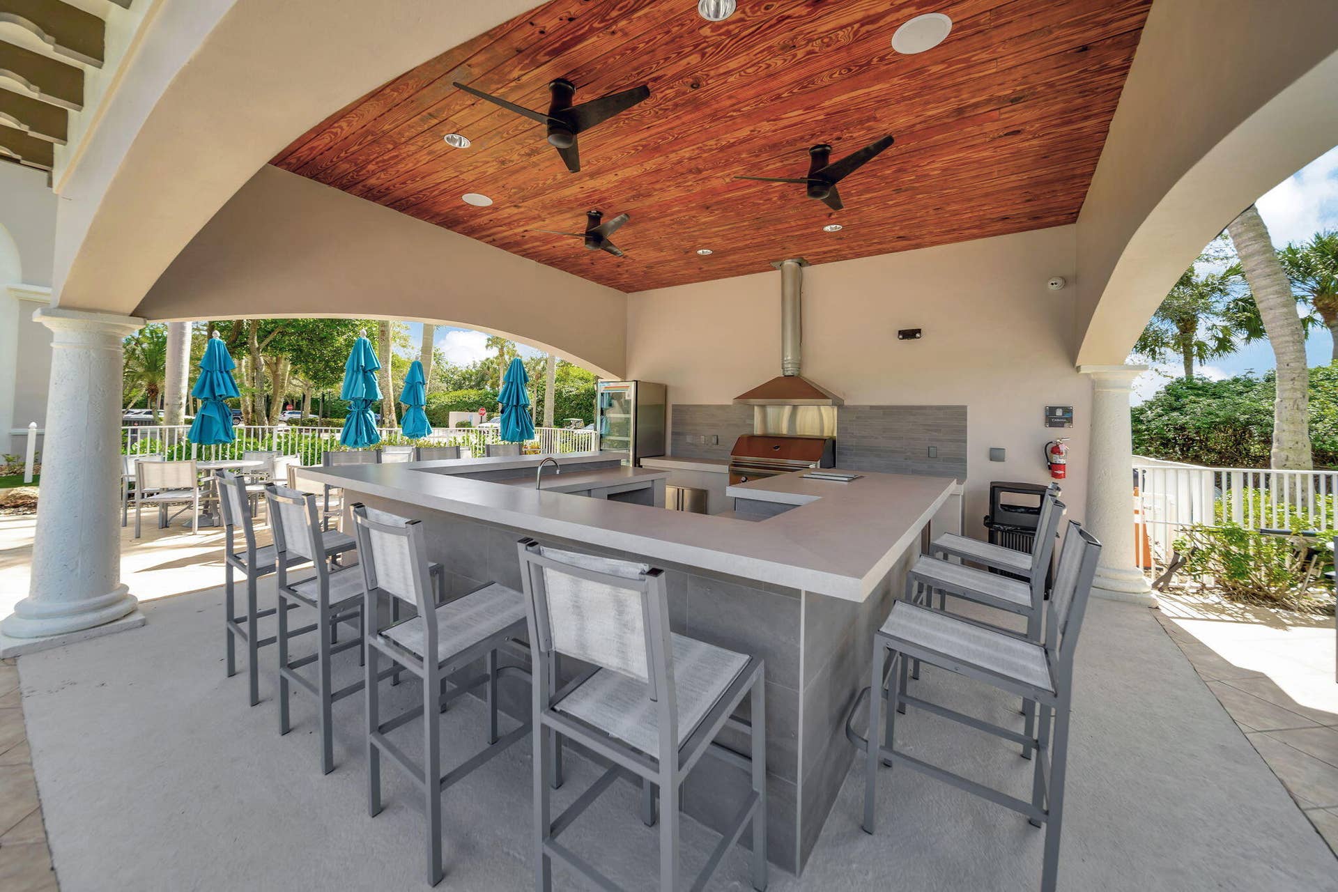 12390 NW 78th Manor, Parkland, FL 33076 The Commons Clubhouse has just delivered a brand new modern exterior and interior, This outside bar/grill area is great for hosting Birthday swim parties, just bring your own sandwiches and cake, Don't forget your swimsuit!