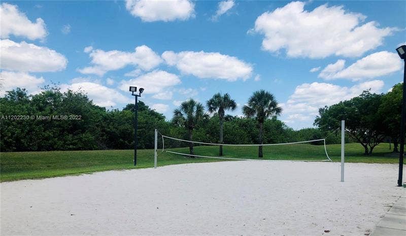12390 NW 78th Manor, Parkland, FL 33076 The Volley ball court is sanded and surrounded by beautiful landscape and lakes