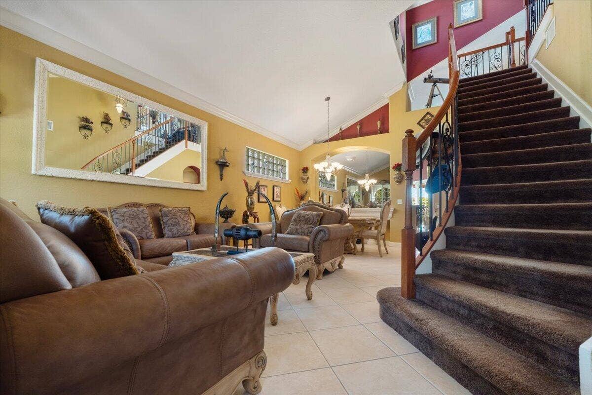 12390 NW 78th Manor, Parkland, FL 33076 The staircase masterpiece, With custom polished wrought iron and a true real hand carved highly polished wooden railing,