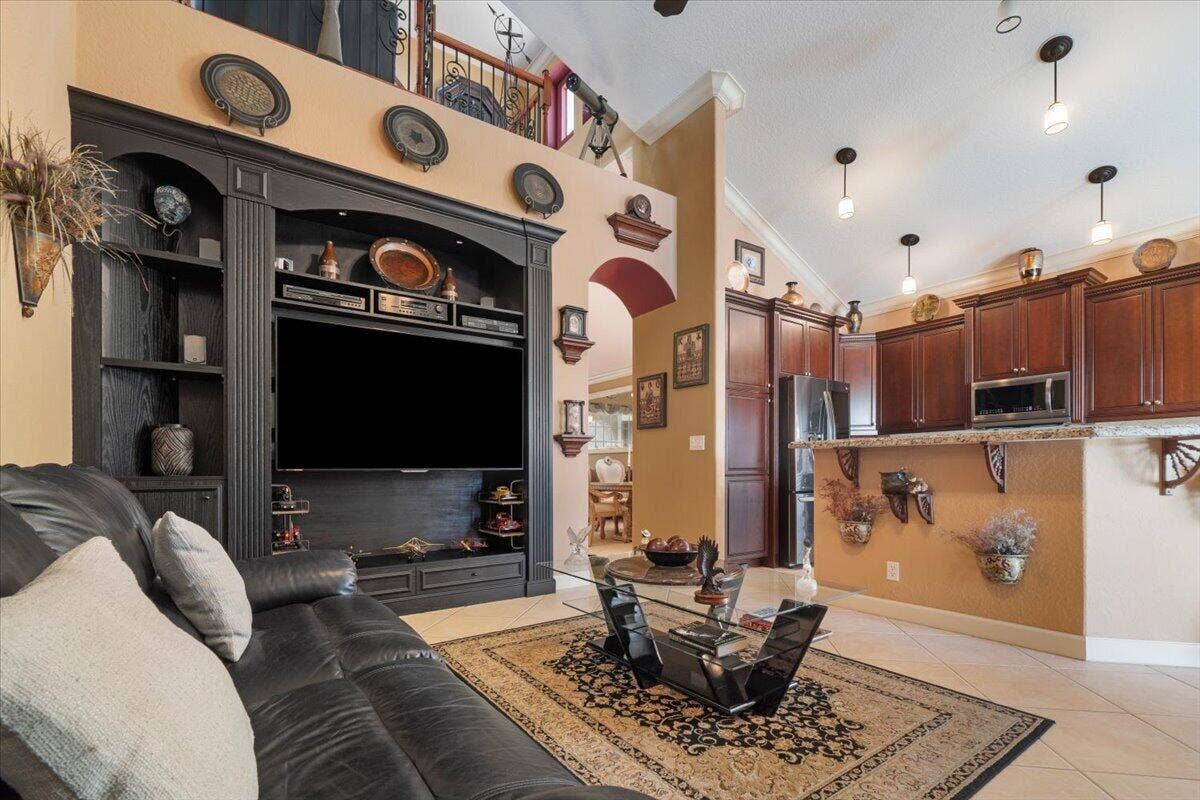 12390 NW 78th Manor, Parkland, FL 33076 This custom designed wall unit has every compartment to store your music system and TV with special hidden compartments.