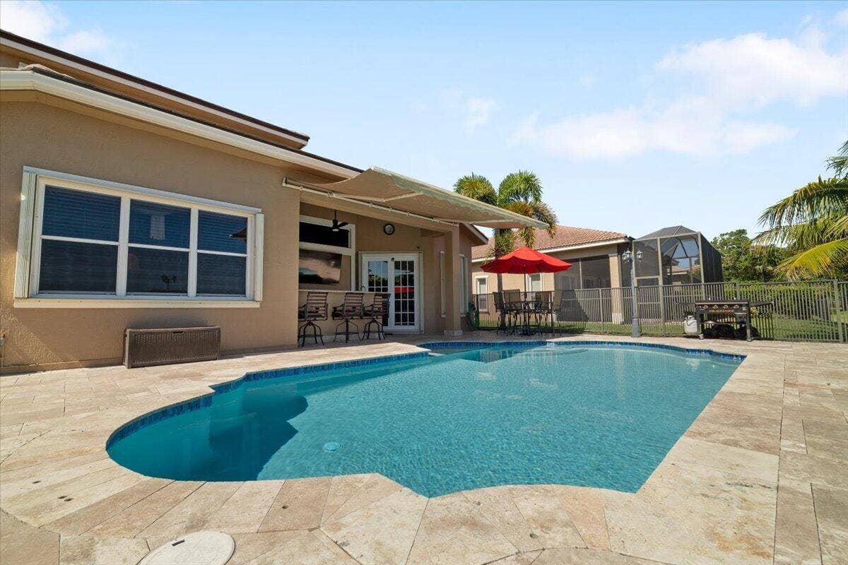 12390 NW 78th Manor, Parkland, FL 33076 Let the kids swim & splash in the multi colored LED pool while the parents Grill and Hibachi and enjoy cocktails at the awning shaded bar.