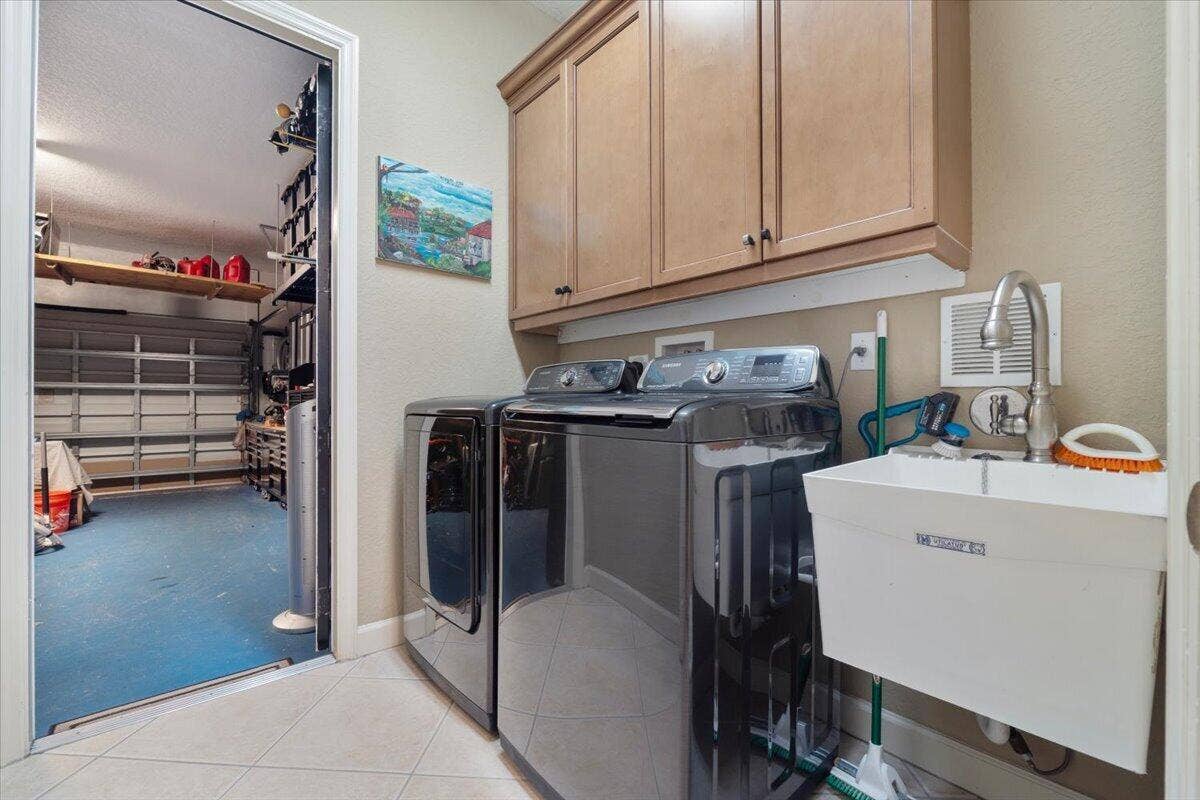 12390 NW 78th Manor, Parkland, FL 33076 The laundry room goes out into the garage,