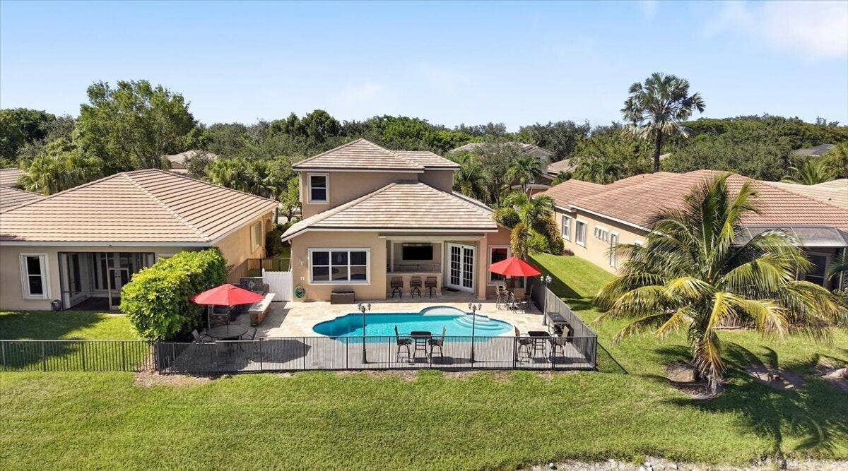 12390 NW 78th Manor, Parkland, FL 33076 The back patio is fully fenced with 2 gates, New Pool, Jerusalem Travertine pavers, built in summer kitchen and built in outside bar & Hibachi grill, Outdoor cobblestone lighting, perfect for family BBQ's & Cocktail parties