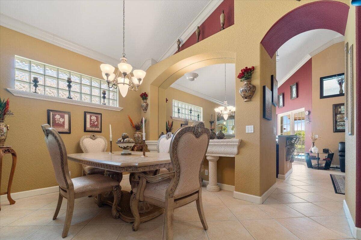 12390 NW 78th Manor, Parkland, FL 33076 This room has a faux stone moldings & columns, buffet bar & mirror for fine dining and you can pull out the table leaves to make a huge extended table for friends & family for Holiday dining and dinner parties