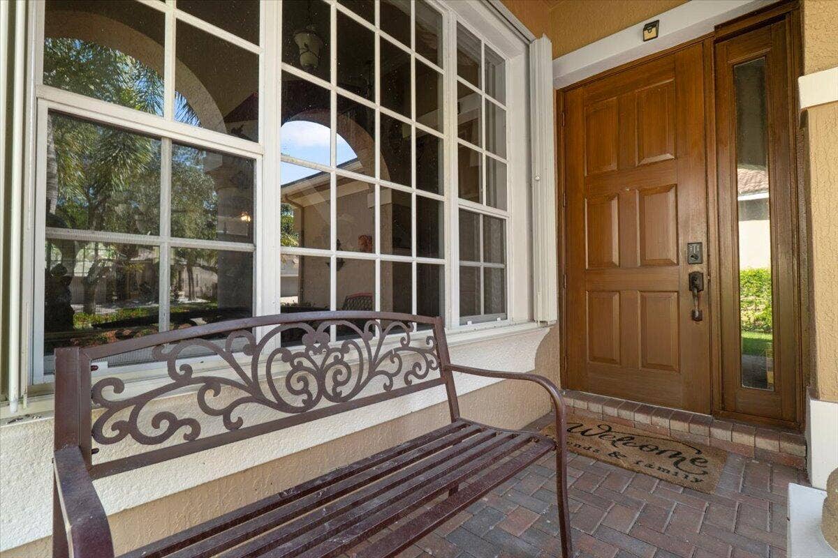 12390 NW 78th Manor, Parkland, FL 33076 Welcome to the solid wooden hurricane protected front door & porchway to watch all the birds and nature passby