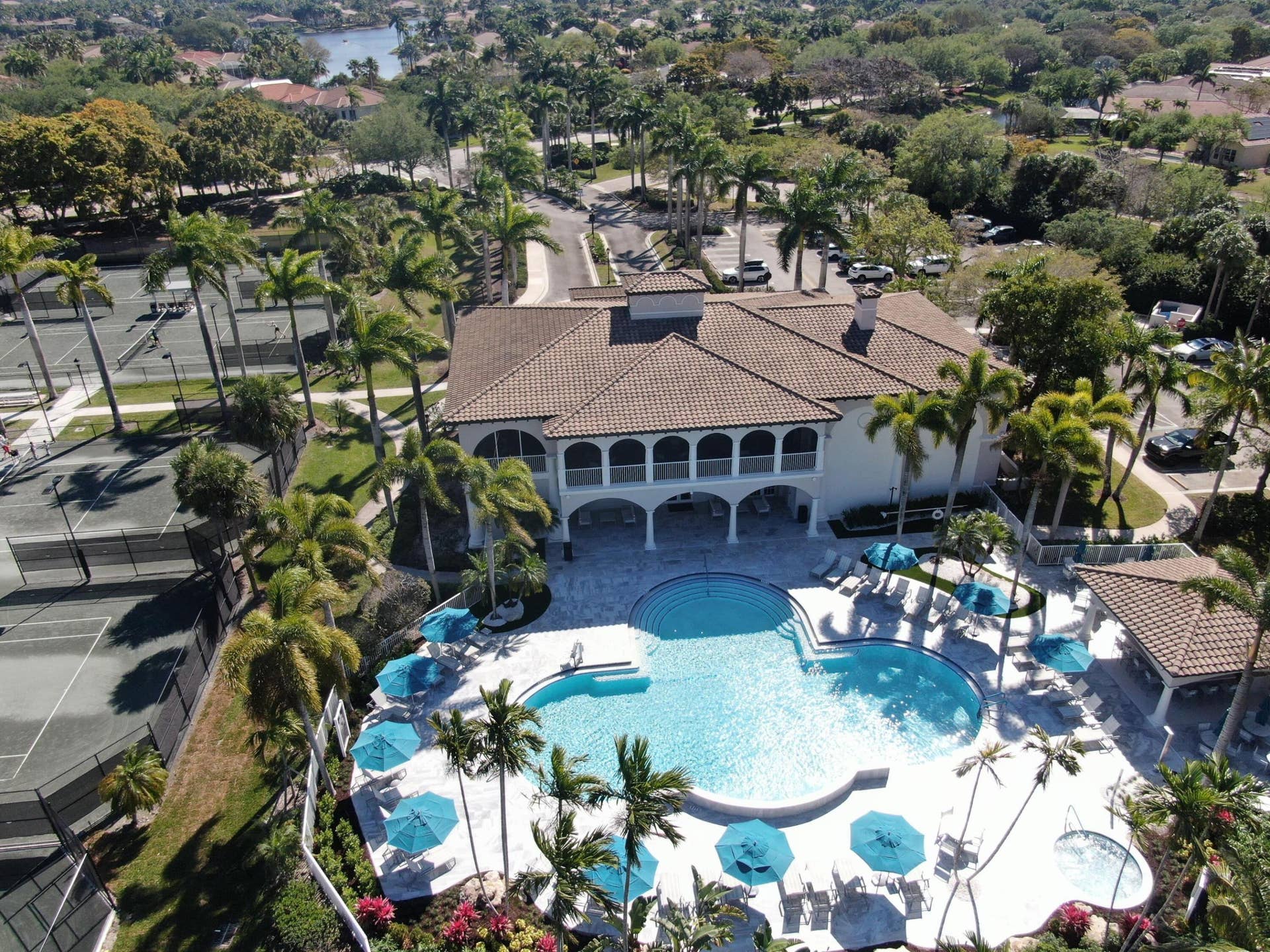 12390 NW 78th Manor, Parkland, FL 33076 An Aerial view of the back of the Commons Clubhouse which overlooks the 220 mile natural preserve of the Everglades which is a beautiful protected land, The view is breathtaking fROm the upstairs balcony of the clubhouse, Sometimes you can see unique birds & wildlife
