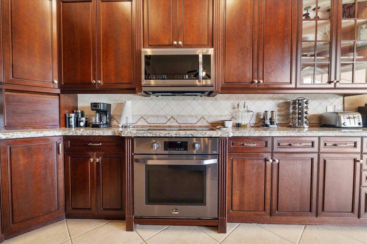 12390 NW 78th Manor, Parkland, FL 33076 Real Wooden kitchen cabinets with granite countertops and L.G matching stainless top of the line newer stainless steal Appliances