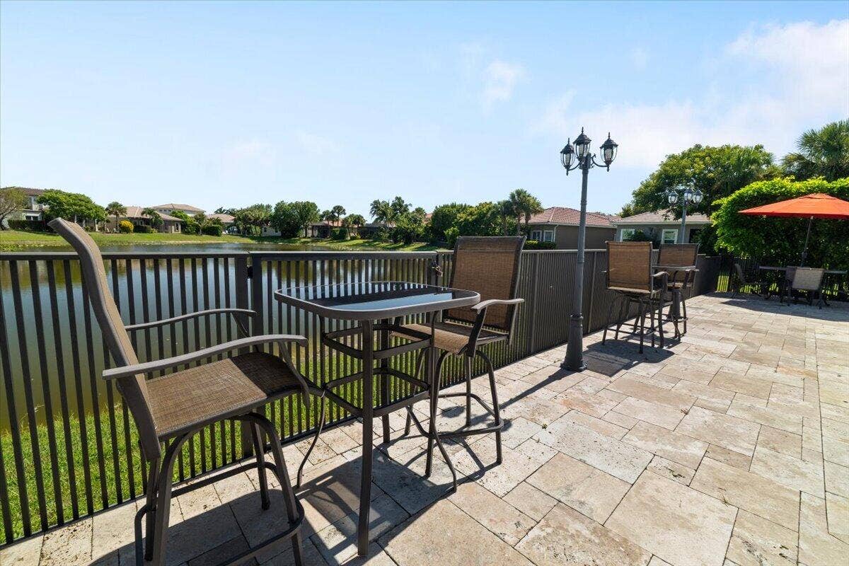 12390 NW 78th Manor, Parkland, FL 33076 Hightop tables with installed cobblestone streetlights surround the LED multi colored pool,