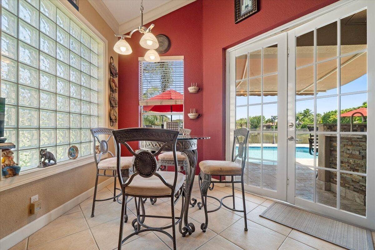 12390 NW 78th Manor, Parkland, FL 33076 This quaint Bistro French Dinette table & chairs with pendant lighting is ideal for dining overlooking the patio and lakeview