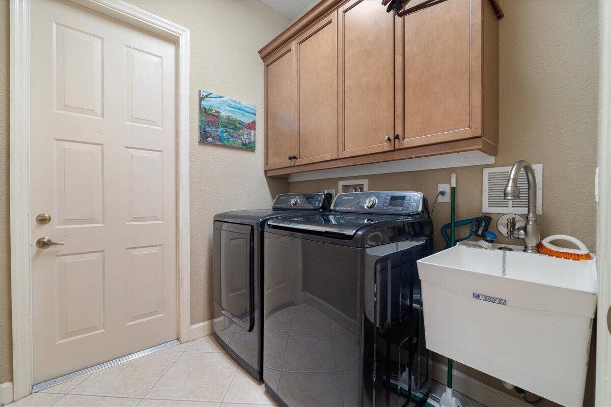 12390 NW 78th Manor, Parkland, FL 33076 Matching Samsung Appliances (washer & Dryer) with a laundry sink, well loved by many buyers and extra storage cupboards above,