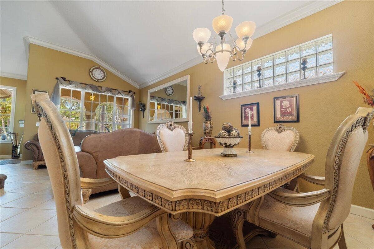 12390 NW 78th Manor, Parkland, FL 33076 Vaulted ceilings adorn this masterpiece with a large formal dining area and chandelier