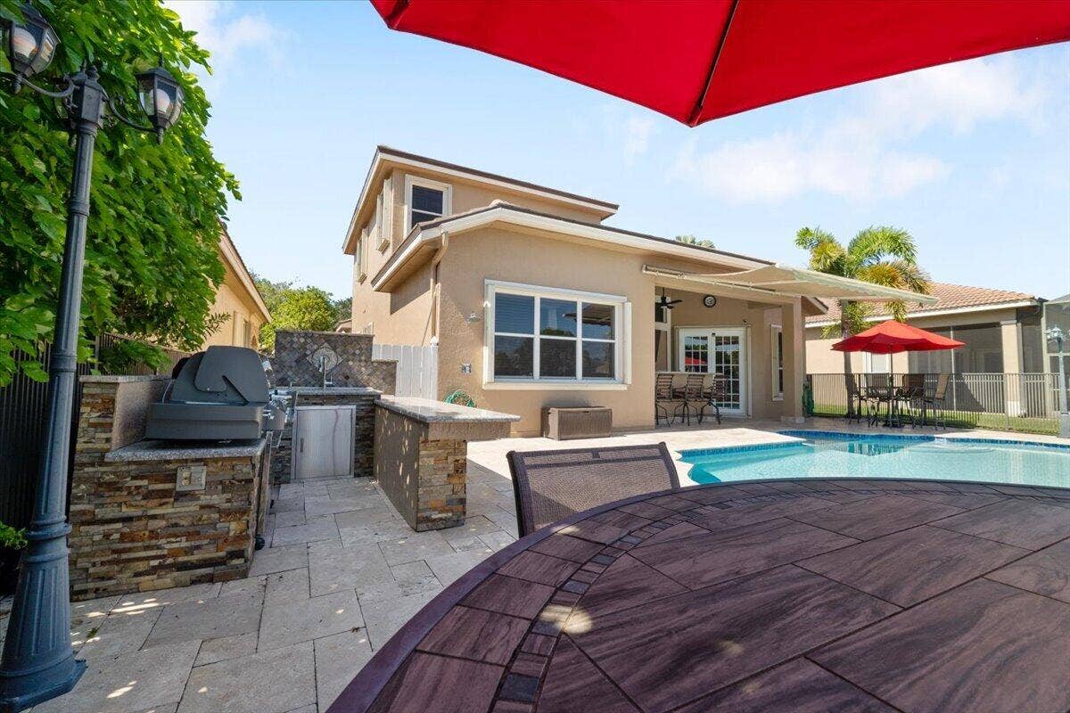 12390 NW 78th Manor, Parkland, FL 33076 This built in summer kitchen is custom built in stone to compliment the cocktail bar, Grill and cocktail and entertain your friends and familes,