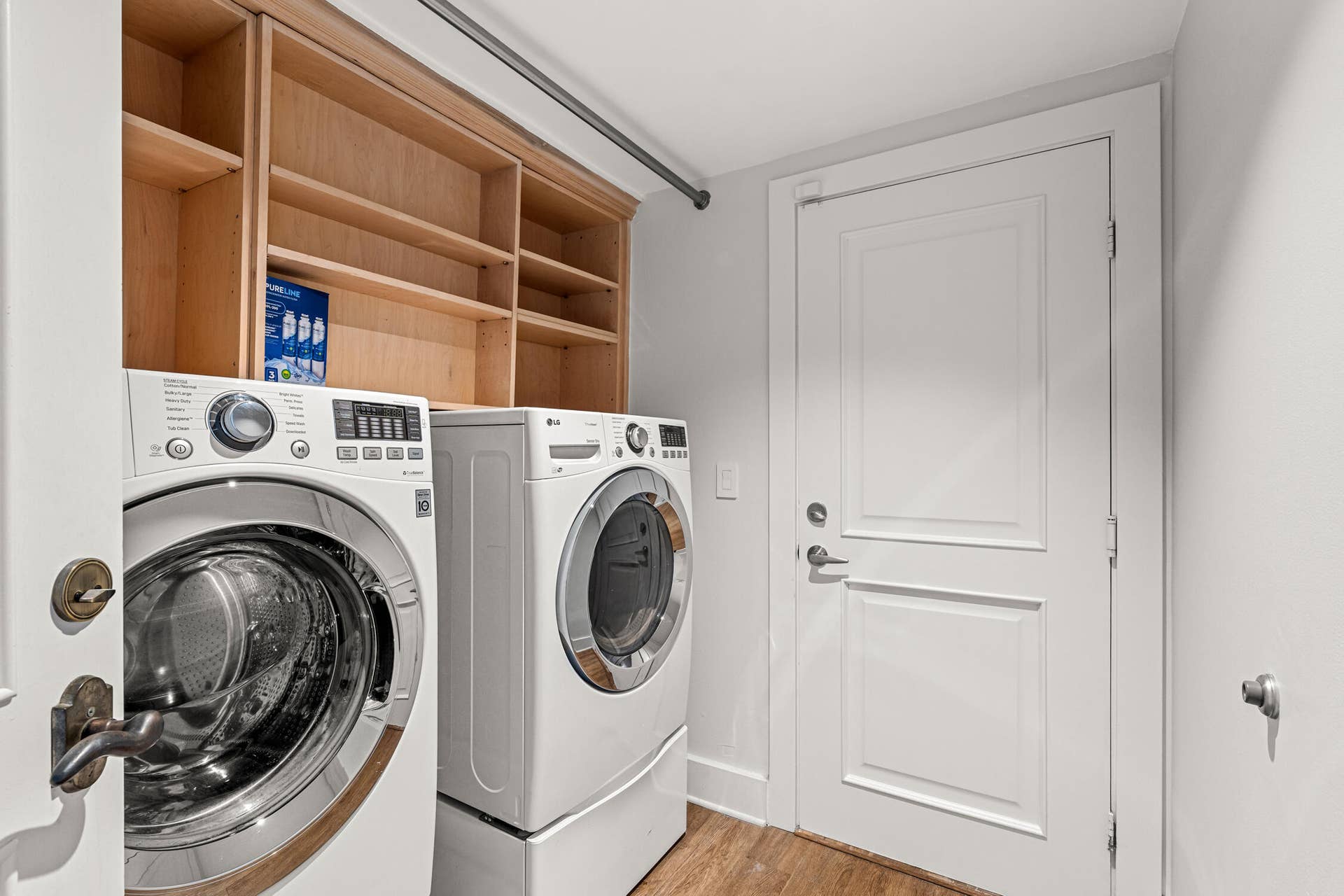 The laundry room has an oversized washer and dryer.