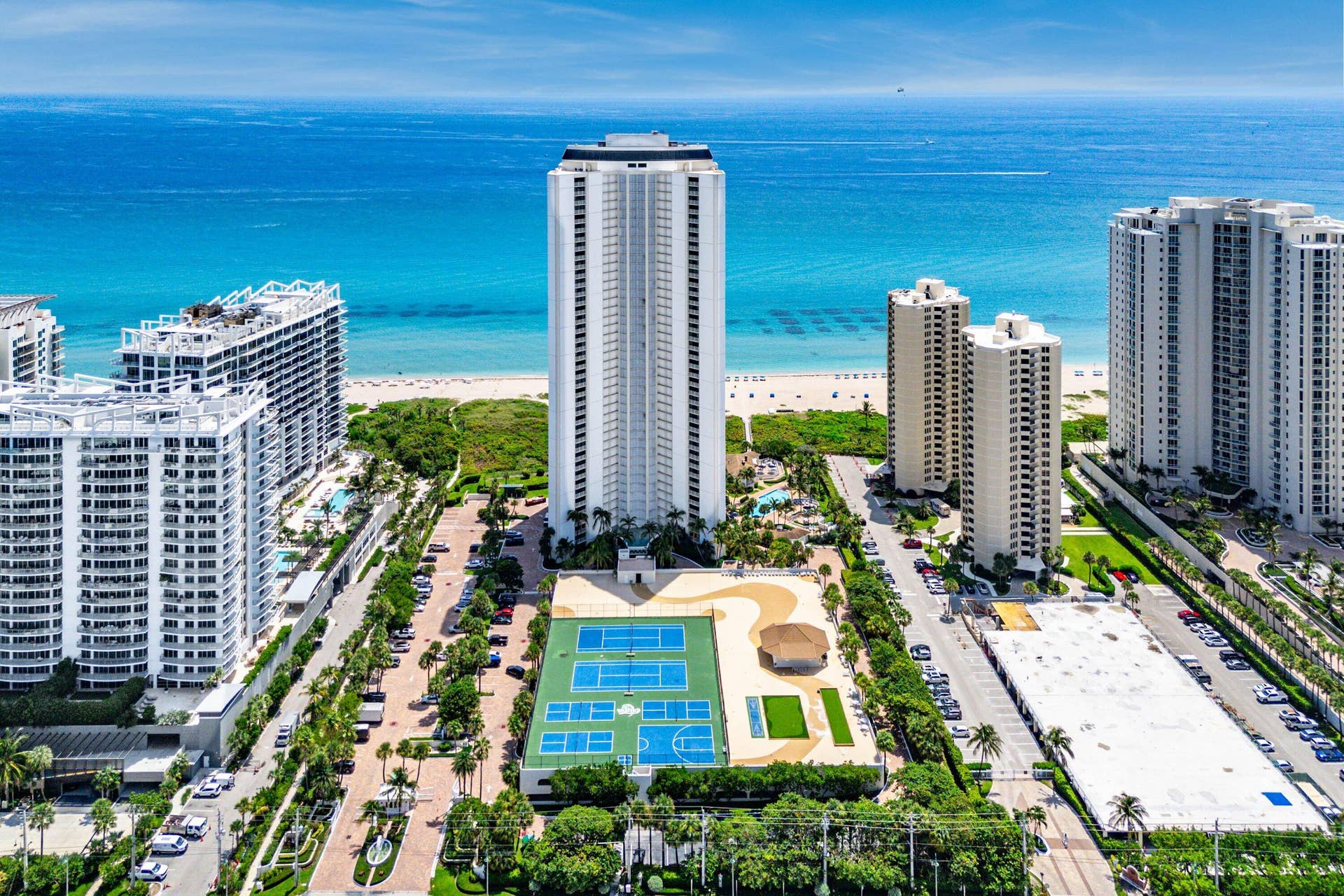 Aerial view highlights Tiara within Singer Island's beachfront skyline and surrounding waterfront community.
