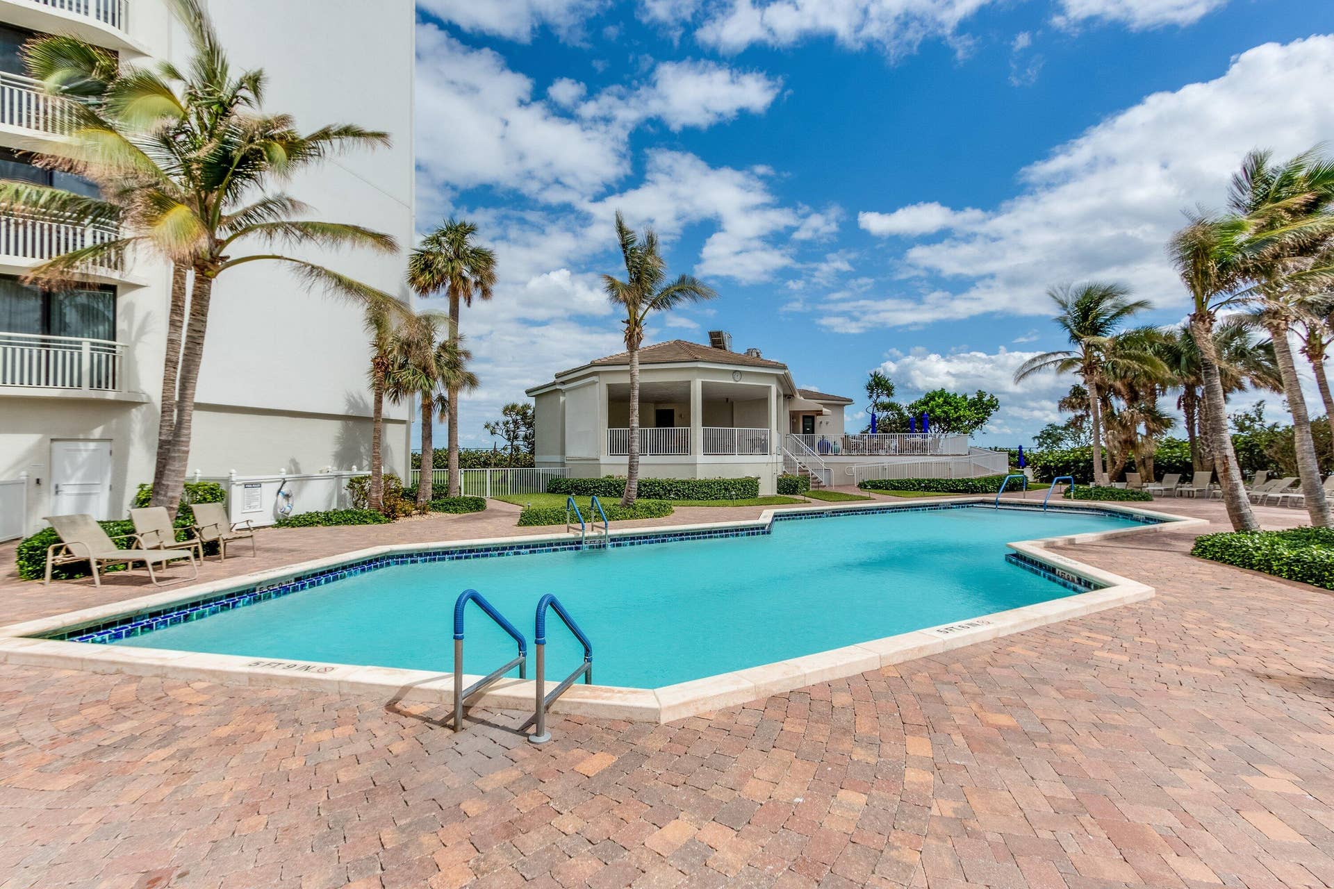 The heated community pool is surrounded by a broad deck, palm landscaping and convenient pavilion space.