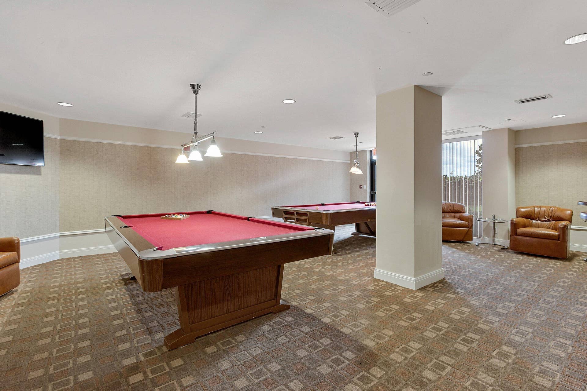 The billiard room offers two pool tables along with lounge seating for recreation and socializing.