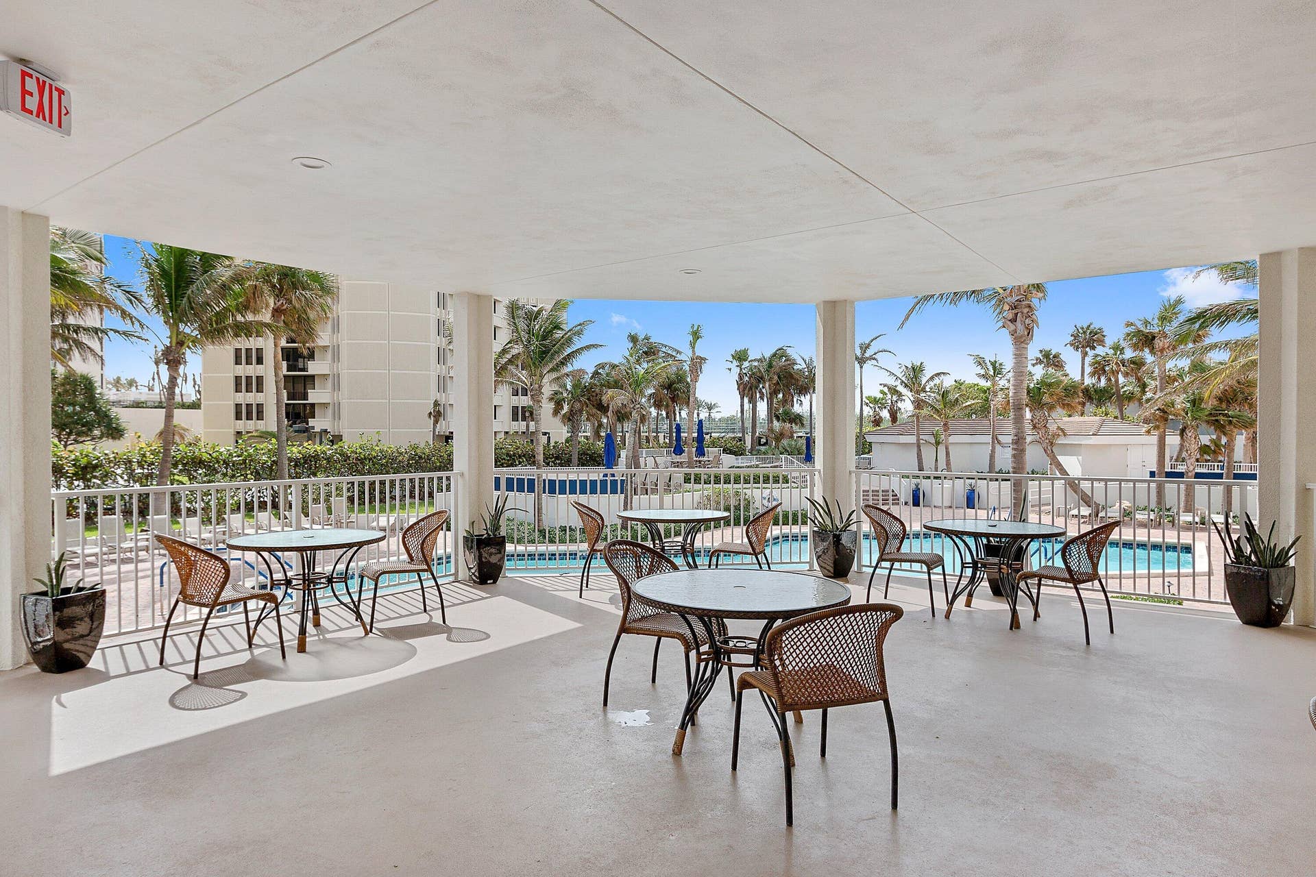 The community caf/restaurant offers outdoor seating framed by views of the swimming pool.