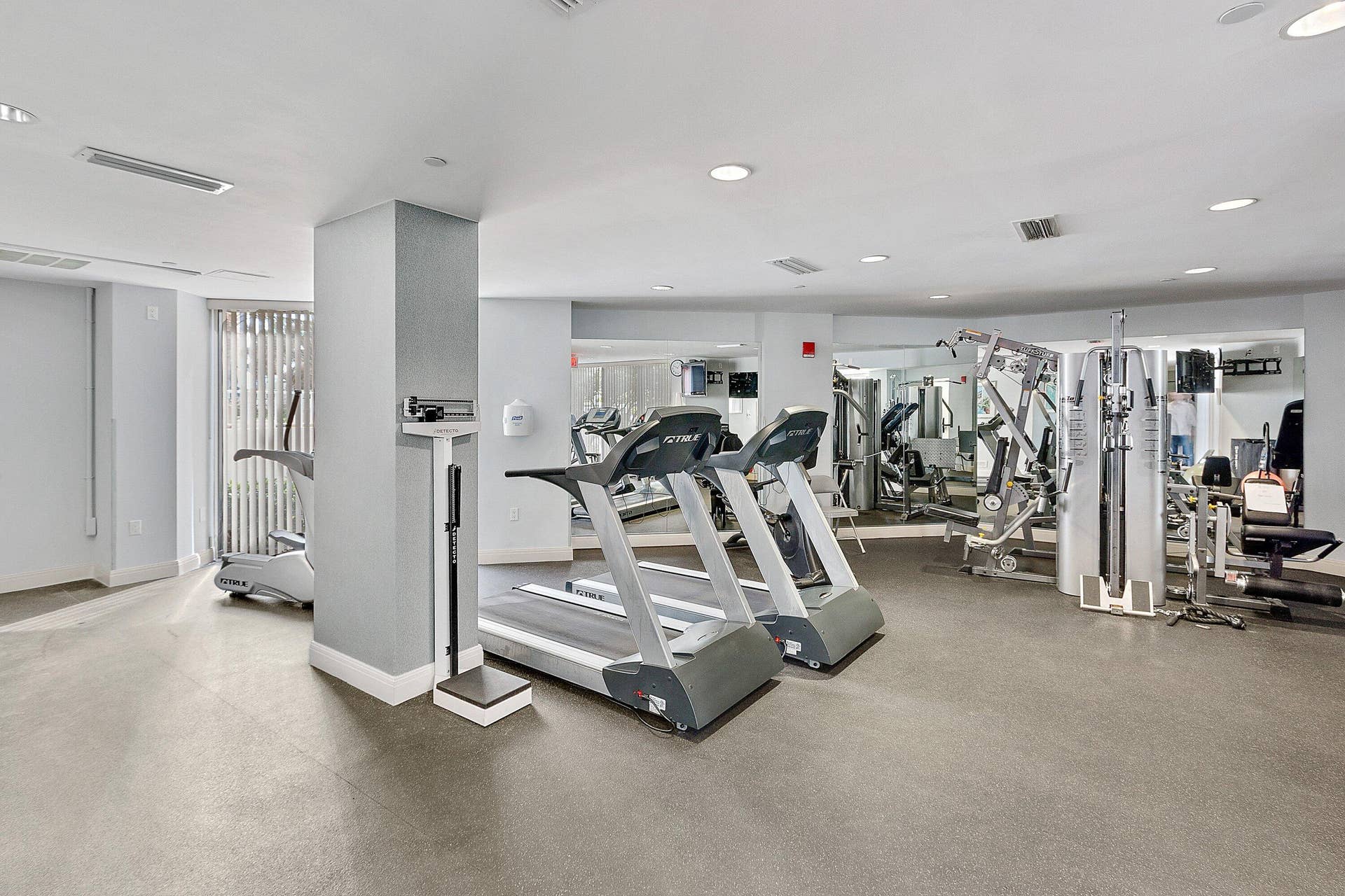 The on-site fitness center includes cardio and strength-training equipment for resident use.