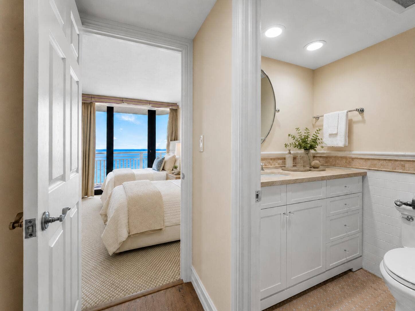 The second full bath includes a long vanity with abundant cabinet storage and a large wall mirror.