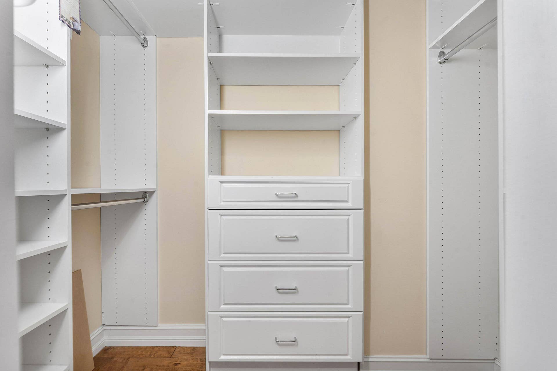 The walk-in closet provides extensive built-in shelving, hanging space and drawer storage.