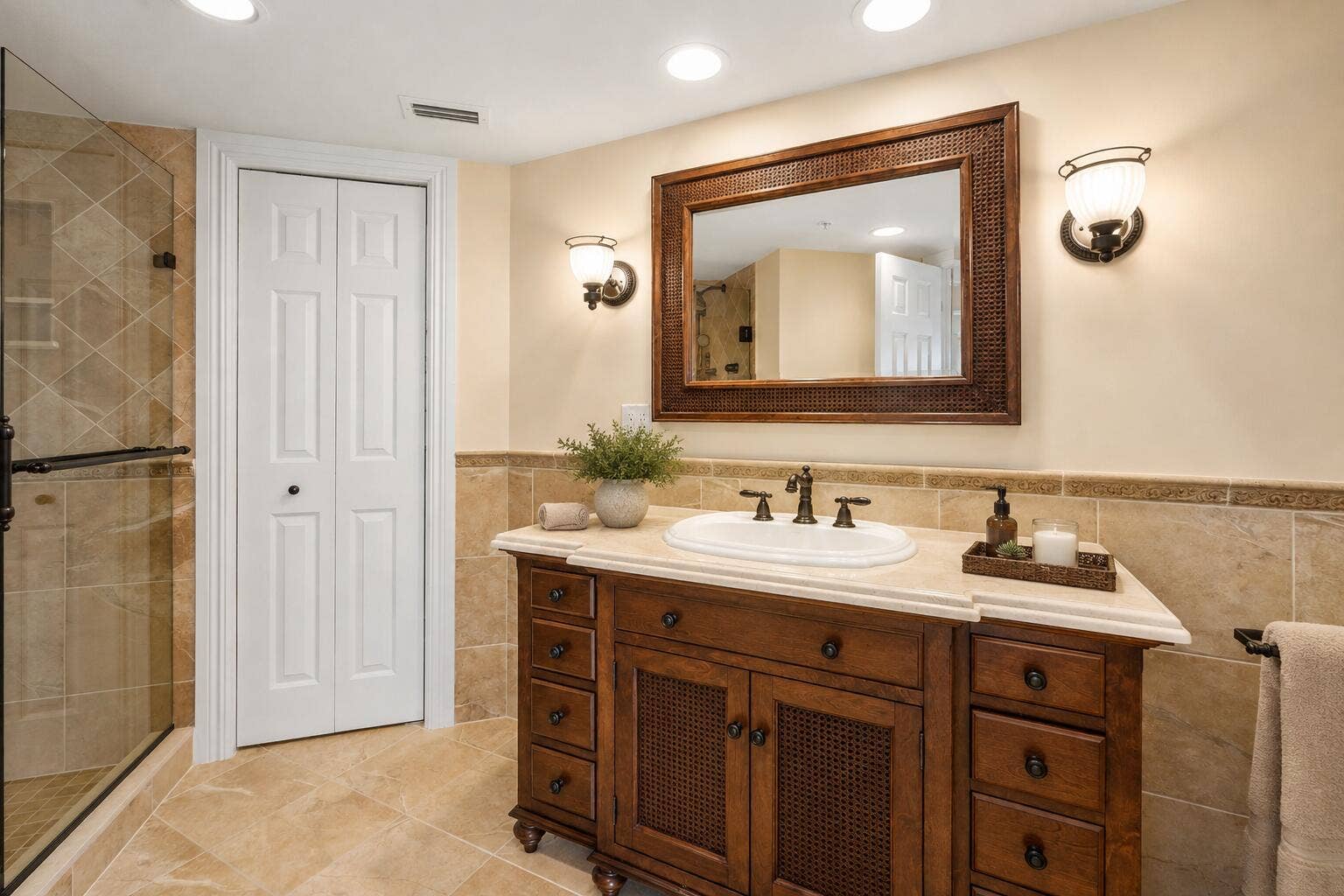 The primary bathroom combines a substantial vanity, tiled finishes and a glass-enclosed shower to create a comfortable, well-appointed en-suite retreat.