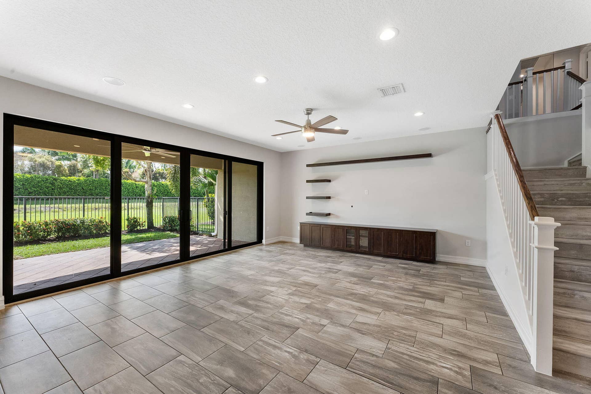 14545 Alabaster Avenue, Delray Beach, FL 33446 Living room leading to outdoor living space via large sliders.