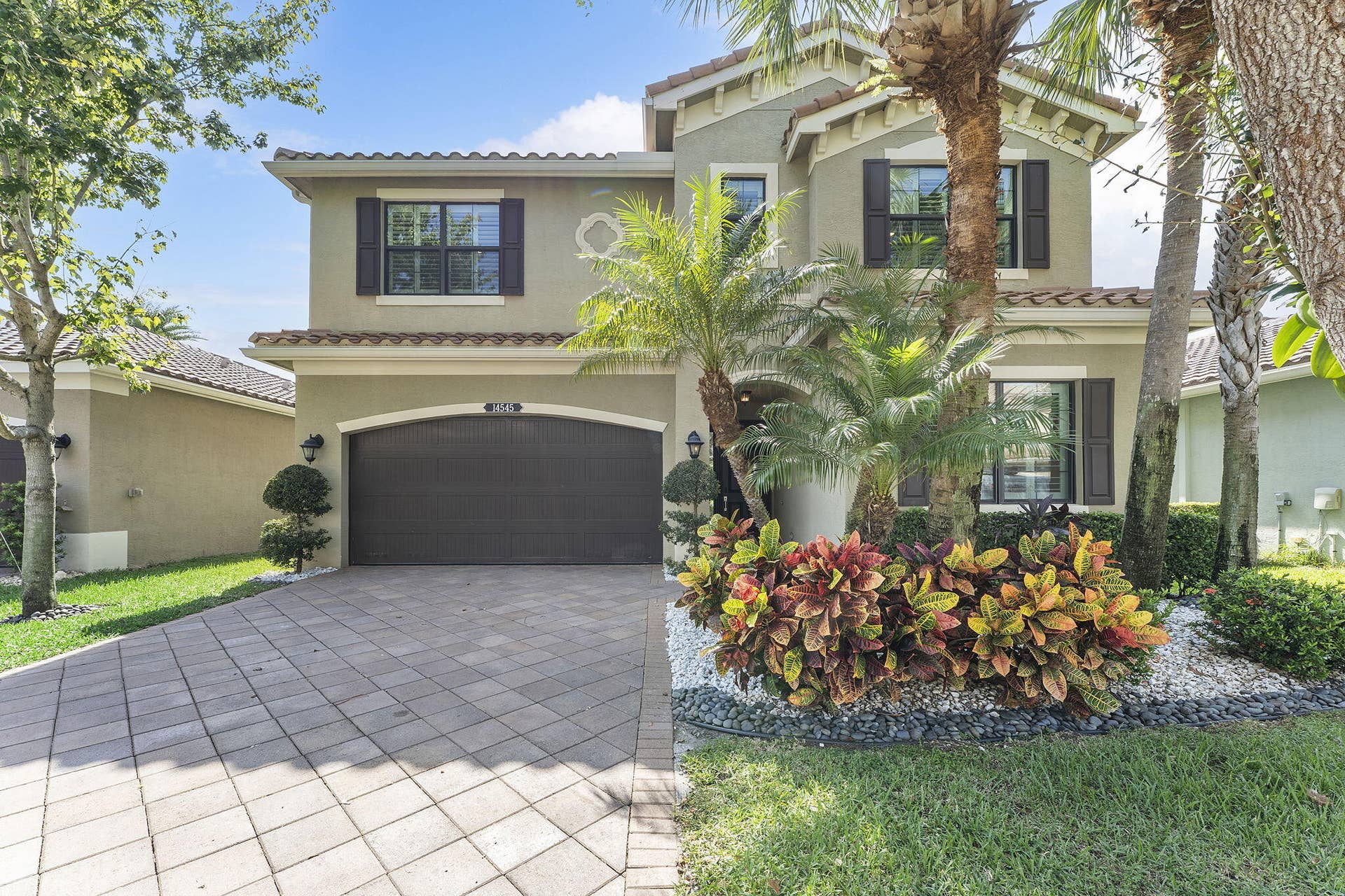 14545 Alabaster Avenue, Delray Beach, FL 33446 Front of home. Beautiful landscapre.
