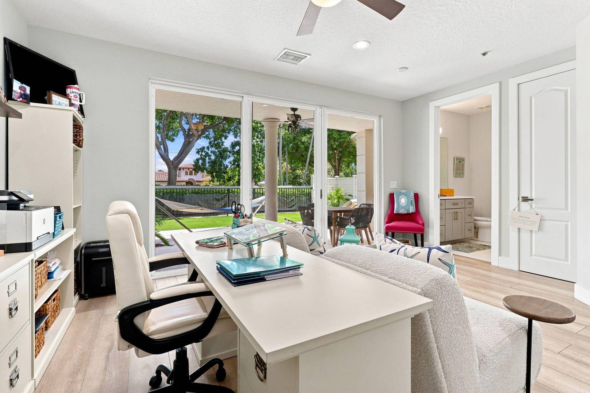 Spacious room featuring luxury vinyl flooring and a ceiling fan