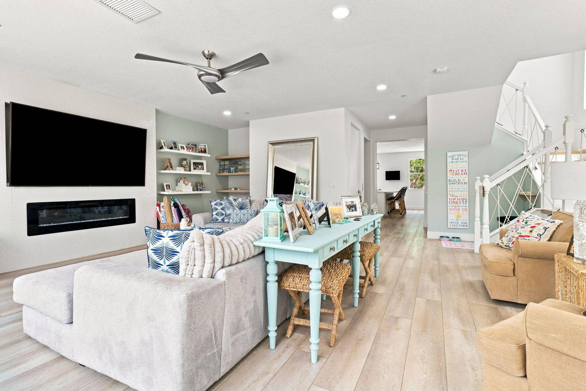 Spacious living area featuring luxury vinyl flooring, a contemporary ceiling fan and recessed lighting