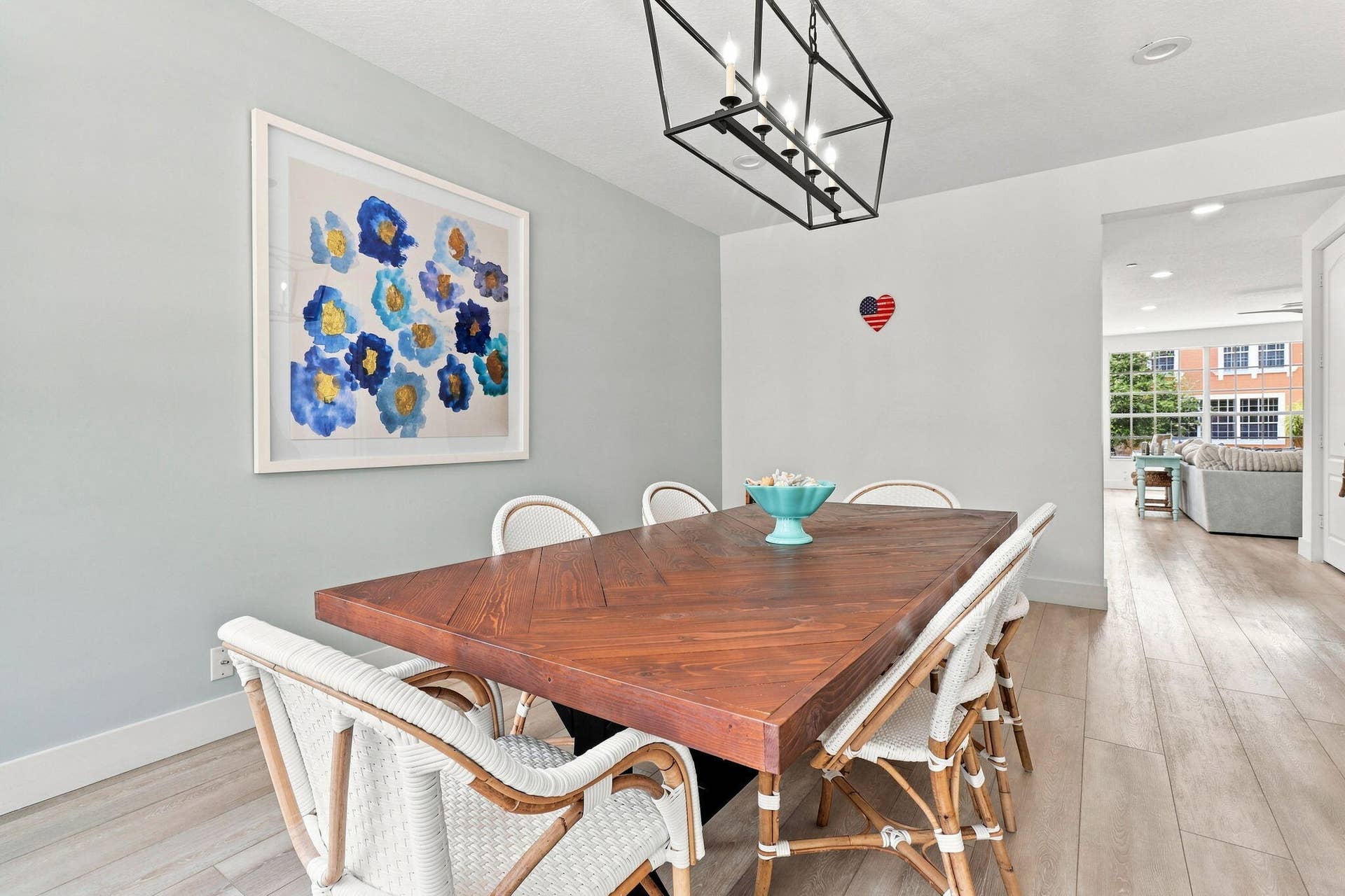 Open dining area with luxury vinyl flooring and a linear chandelier