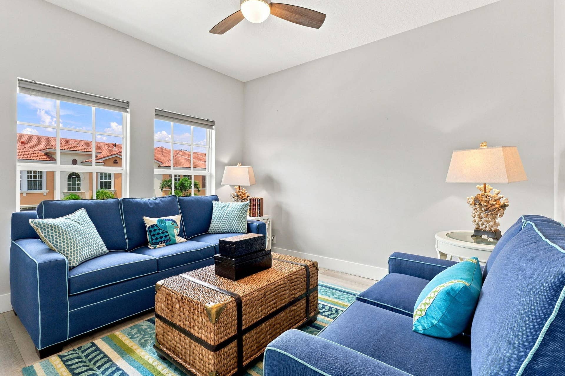 Recessed lighting, wood-finish ceiling fan and two large windows with grid patterns