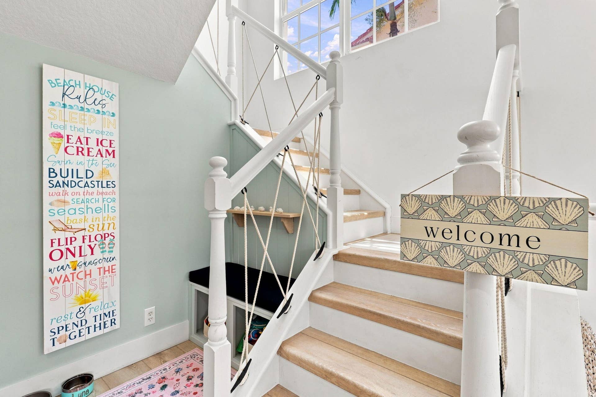 Light wood-finish stair treads with white risers and a white painted balustrade