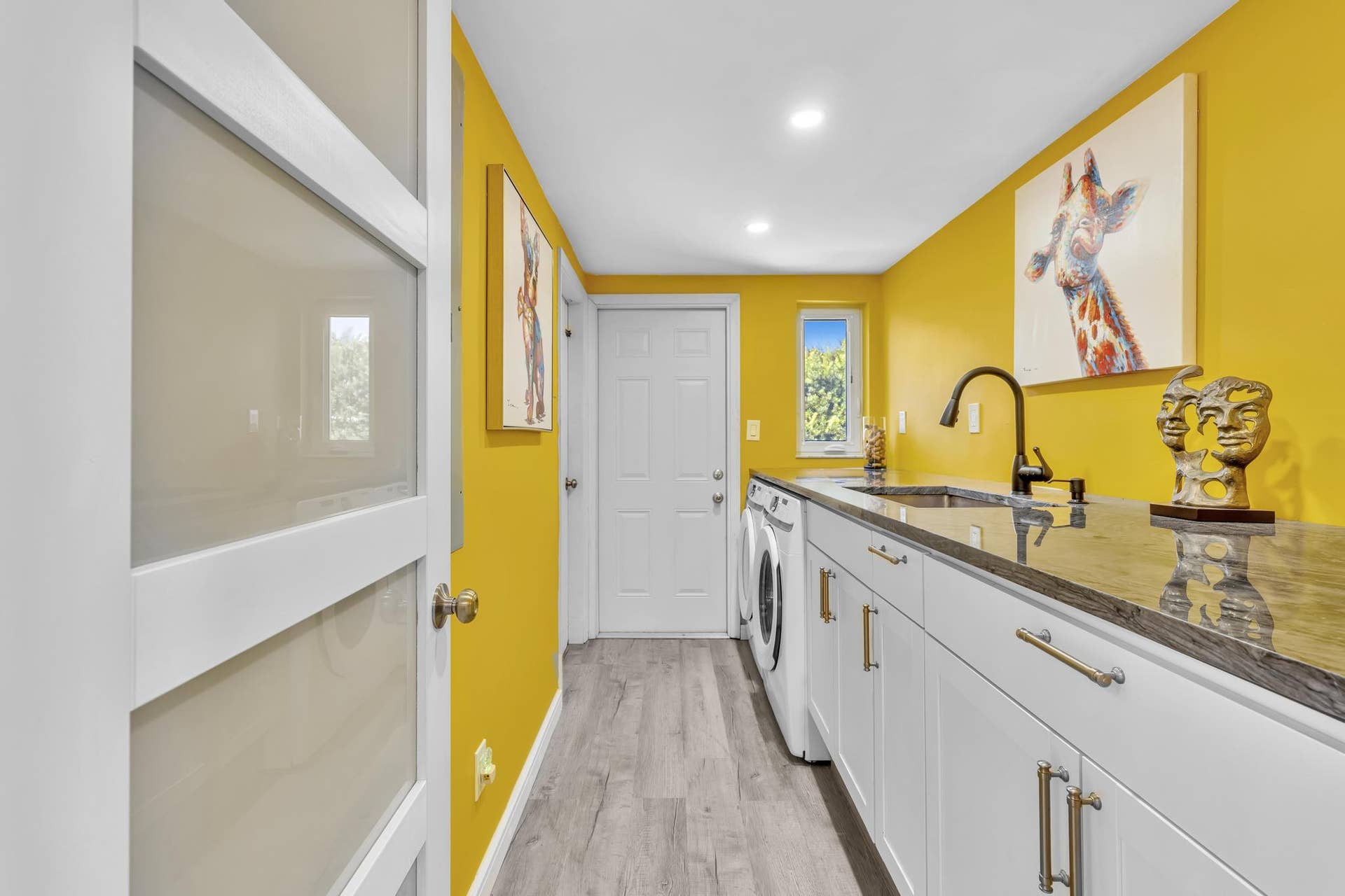 600 N VICTORIA Terrace, Fort Lauderdale, FL 33304 Laundry Room with washer and dryer, built in sink, and garage access.