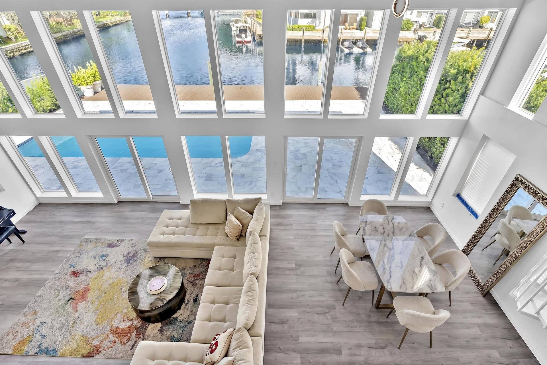 600 N VICTORIA Terrace, Fort Lauderdale, FL 33304 overview of living room with floor to ceiling windows. Virtually Staged