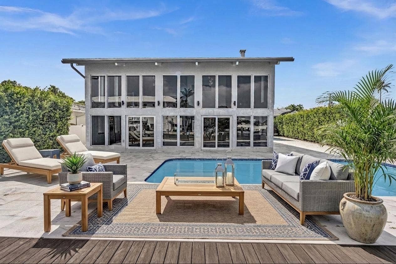 600 N VICTORIA Terrace, Fort Lauderdale, FL 33304 Back of home with lounge chaises and patio furniture. Virtually Staged
