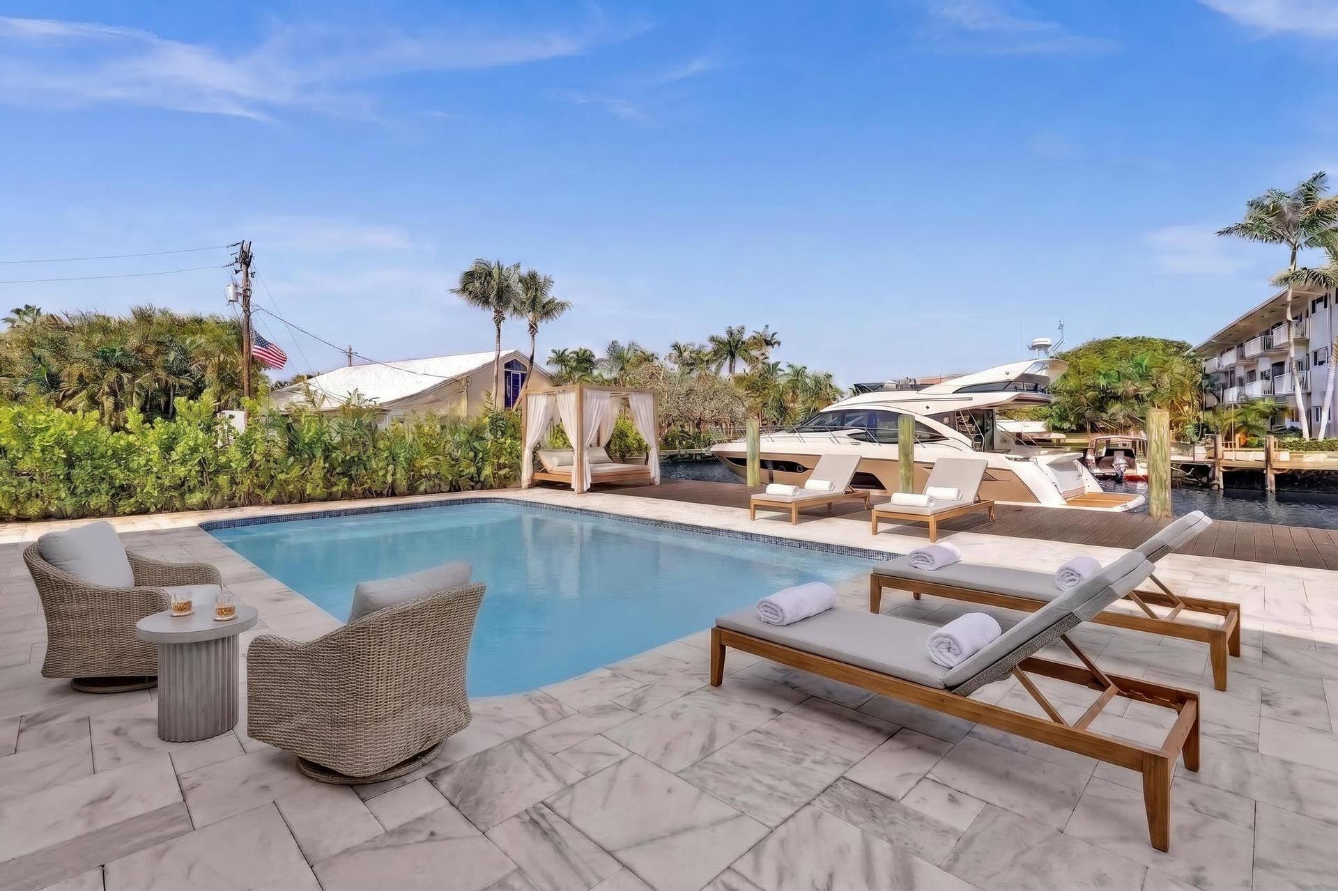 600 N VICTORIA Terrace, Fort Lauderdale, FL 33304 Back of home with lounge chaises and patio furniture. Virtually Staged