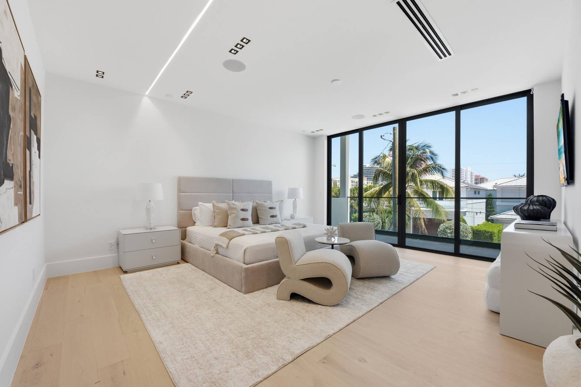 Full-height windows, recessed lighting, wood-finish flooring, and integrated ceiling speakers
