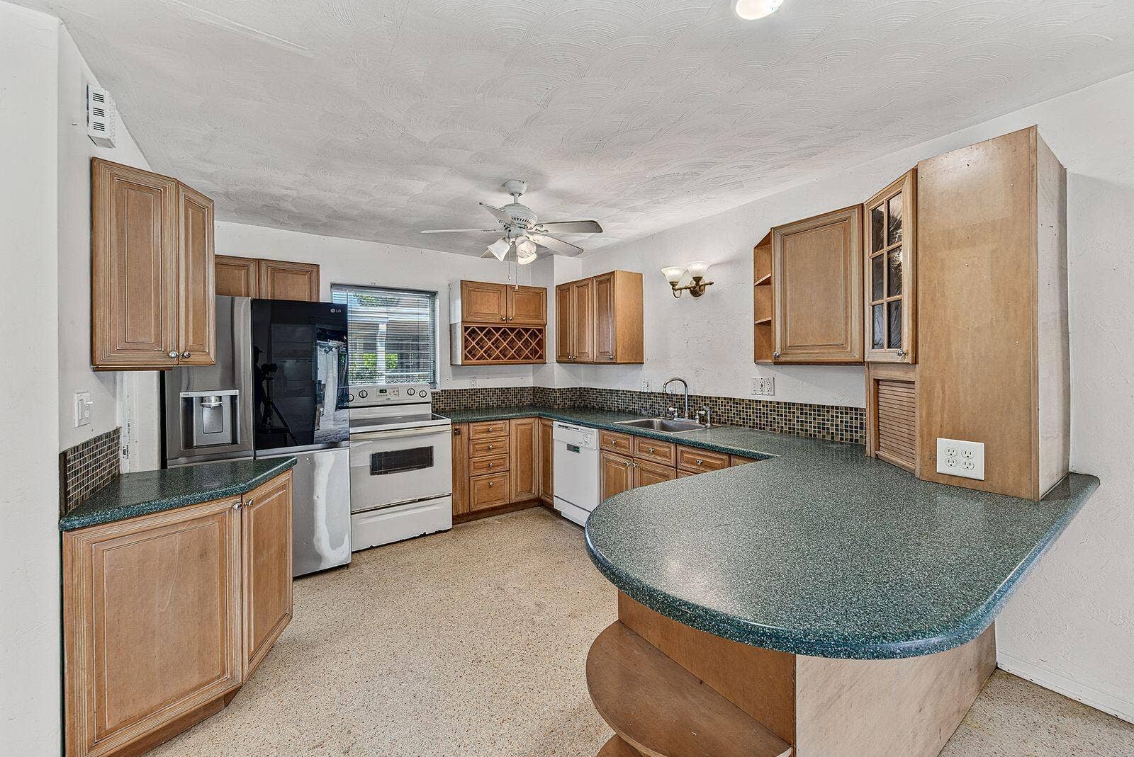 201 NE 29th Street, Wilton Manors, FL 33334 Large kitchen with abundant cabinetry, extensive counter space and a curved breakfast bar.