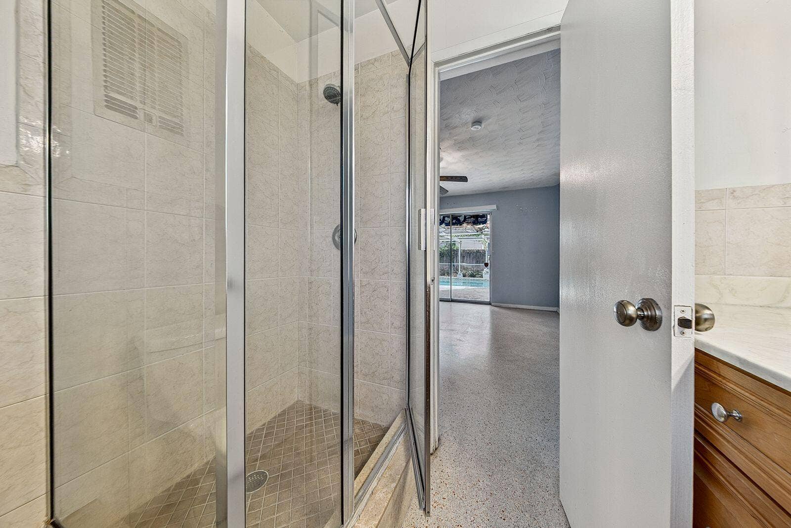 201 NE 29th Street, Wilton Manors, FL 33334 Detailed view of the tiled shower serving the adjoining bedroom suite.