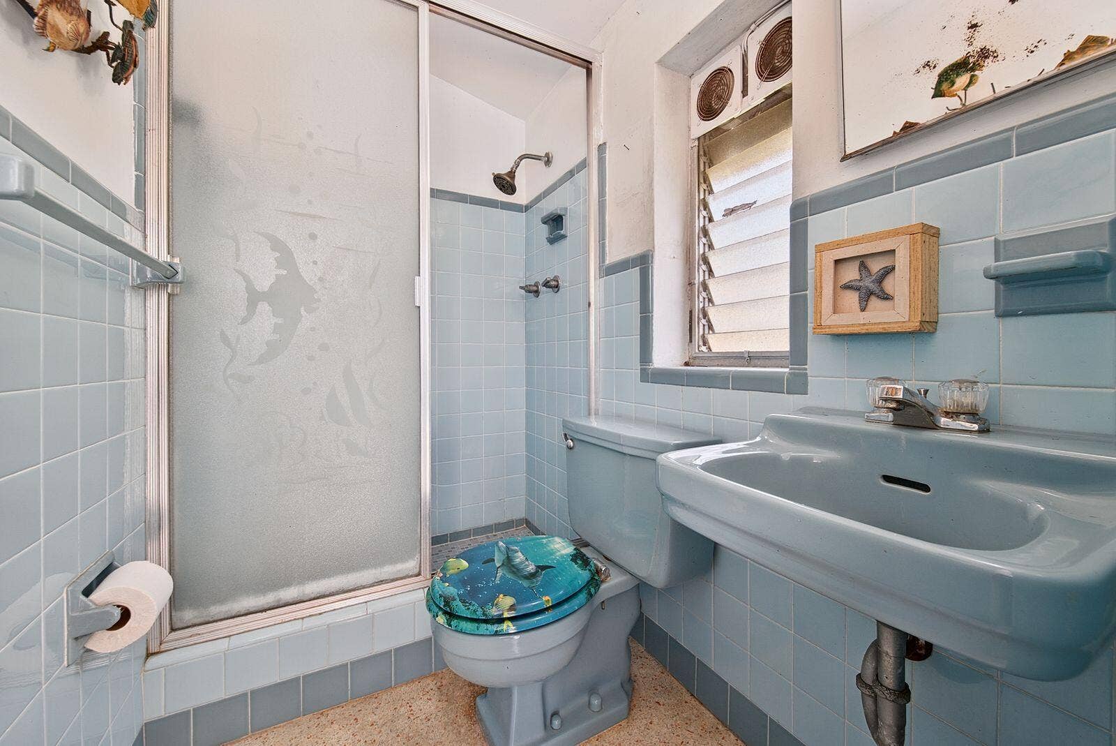 201 NE 29th Street, Wilton Manors, FL 33334 Full bathroom with a tiled shower, pedestal sink and window providing natural light.